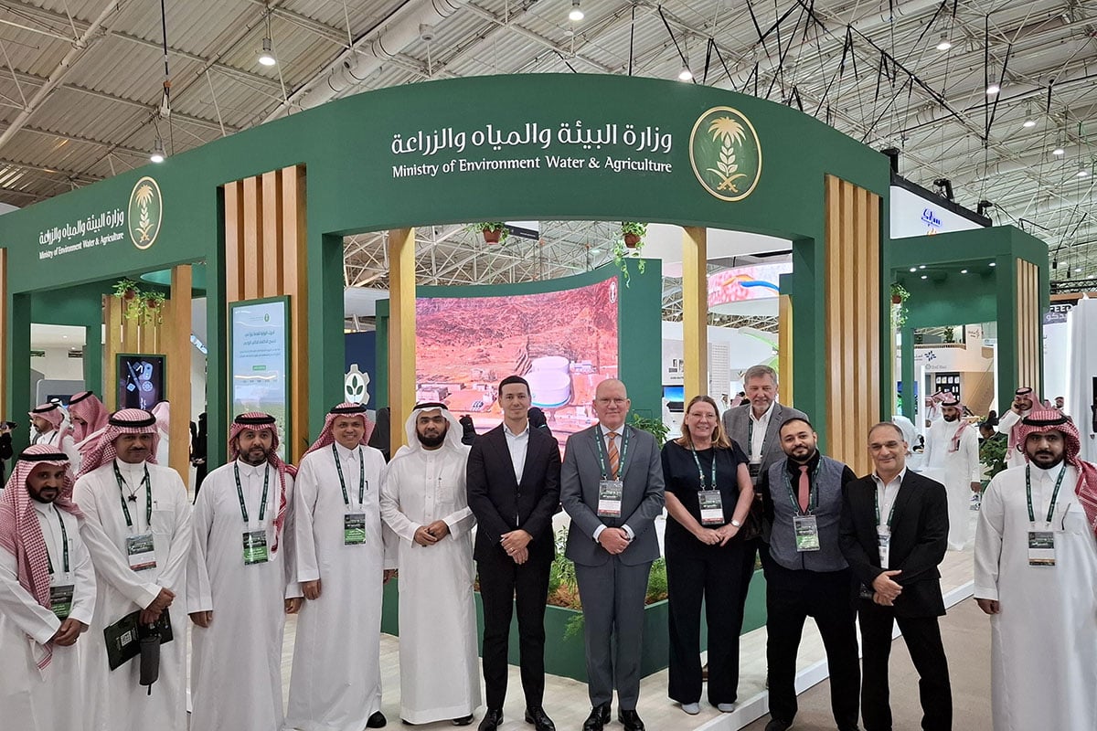 A group of individuals standing in front of a green exhibition stand with Arabic text and logos, indicating an event related to the Ministry of Environment, Water, and Agriculture. The individuals are wearing formal attire, and some are wearing name badges. A group of individuals standing in front of a green exhibition stand with Arabic text and logos, indicating an event related to the Ministry of Environment, Water, and Agriculture. The individuals are wearing formal attire, and some are wearing name badges.